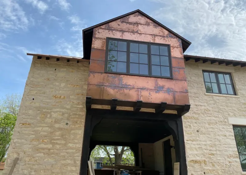Copper metal panel facade on a stone building for Metal Roof Coating in Columbia